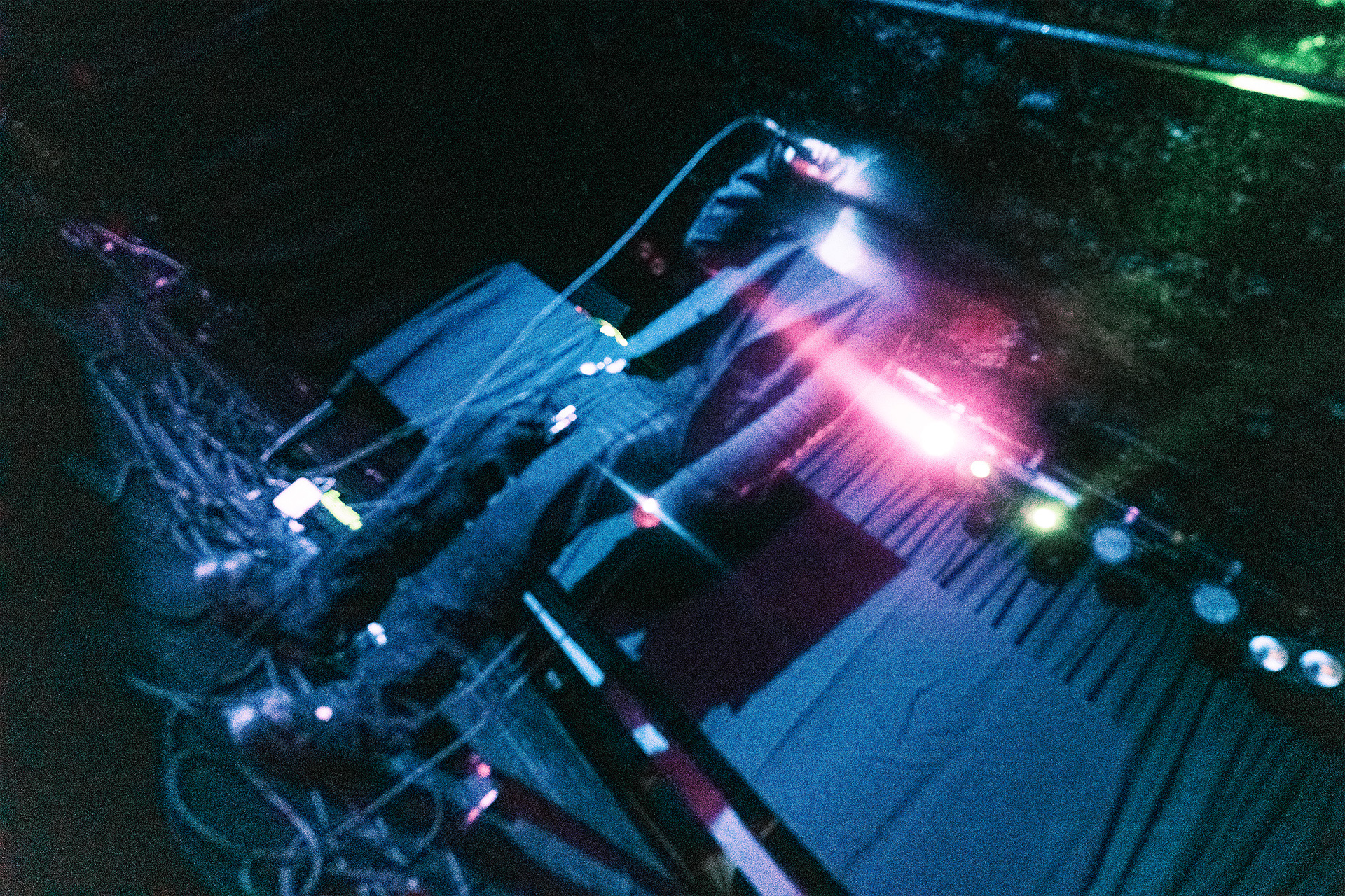 keyboard and stage gear under blue and pink light